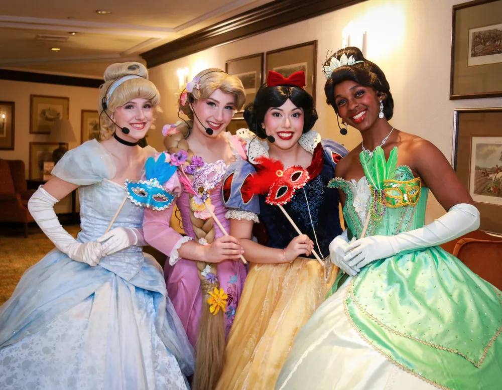 Princesses holding masquerade masks at The Old Mill Toronto