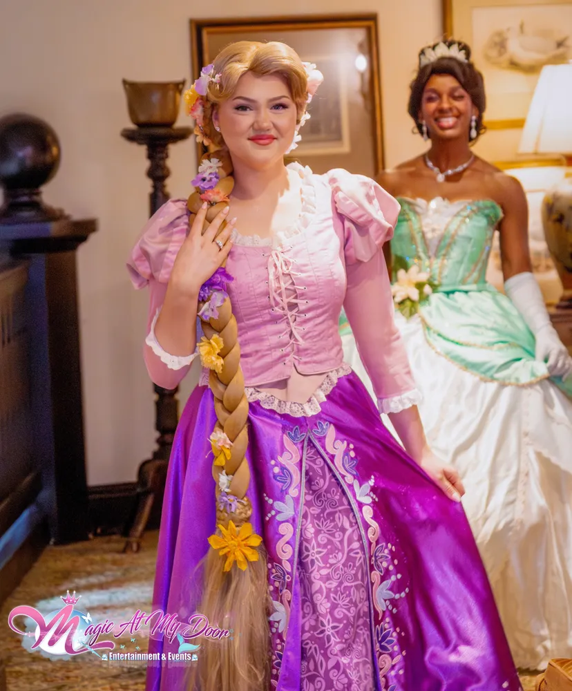 Rapunzel and Tiana princess performers at an indoor event